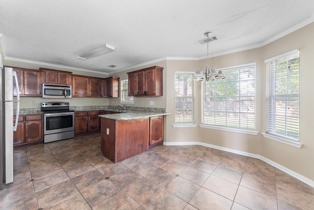 kitchen with sink, decorative light fixtures, ornamental molding, a notable chandelier, and stainless steel appliances