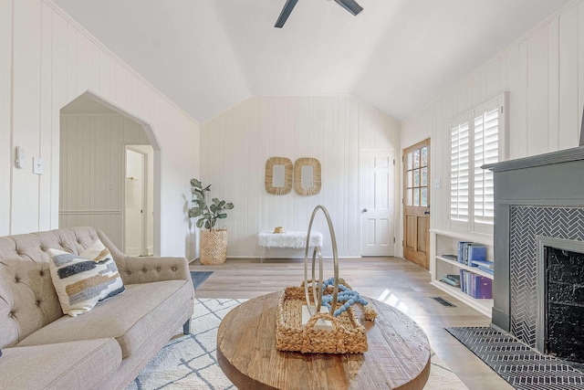 living room featuring vaulted ceiling, ceiling fan, and light hardwood / wood-style floors