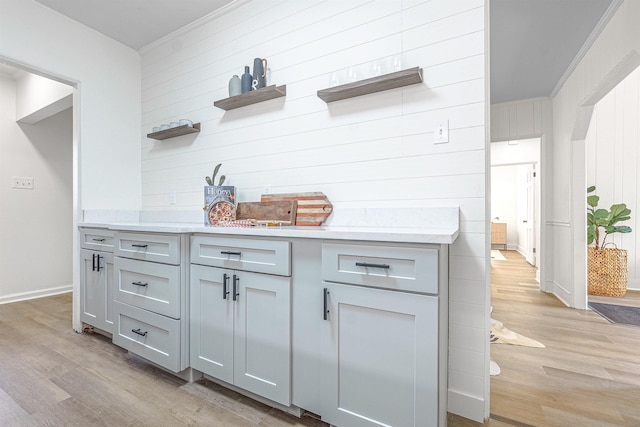 kitchen with gray cabinetry and light hardwood / wood-style floors