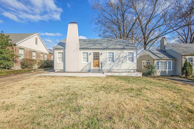 view of front of house with a patio and a front lawn