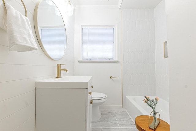 bathroom featuring vanity, crown molding, a bathtub, and toilet