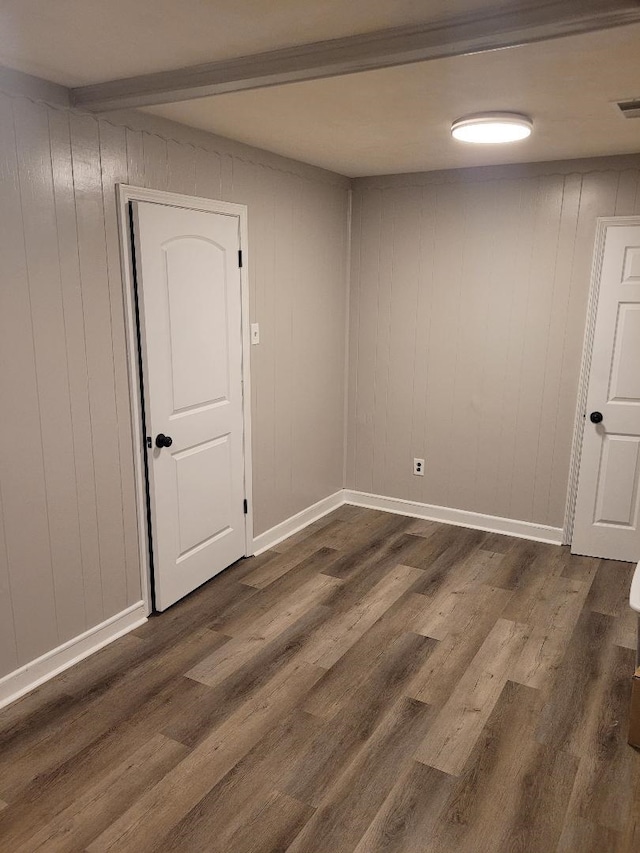 unfurnished room featuring dark wood-type flooring