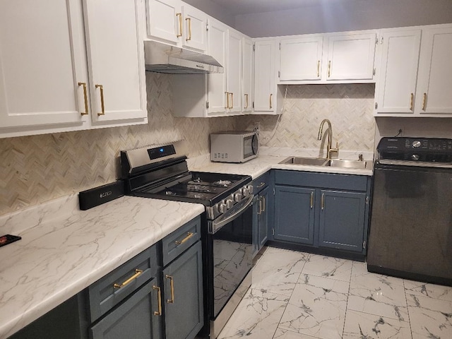 kitchen featuring sink, stainless steel appliances, tasteful backsplash, white cabinets, and washer / clothes dryer