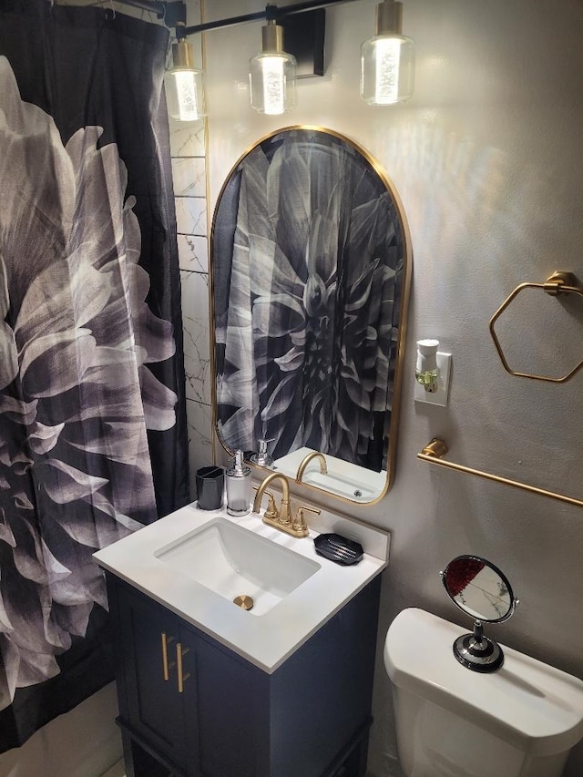 bathroom featuring vanity and toilet