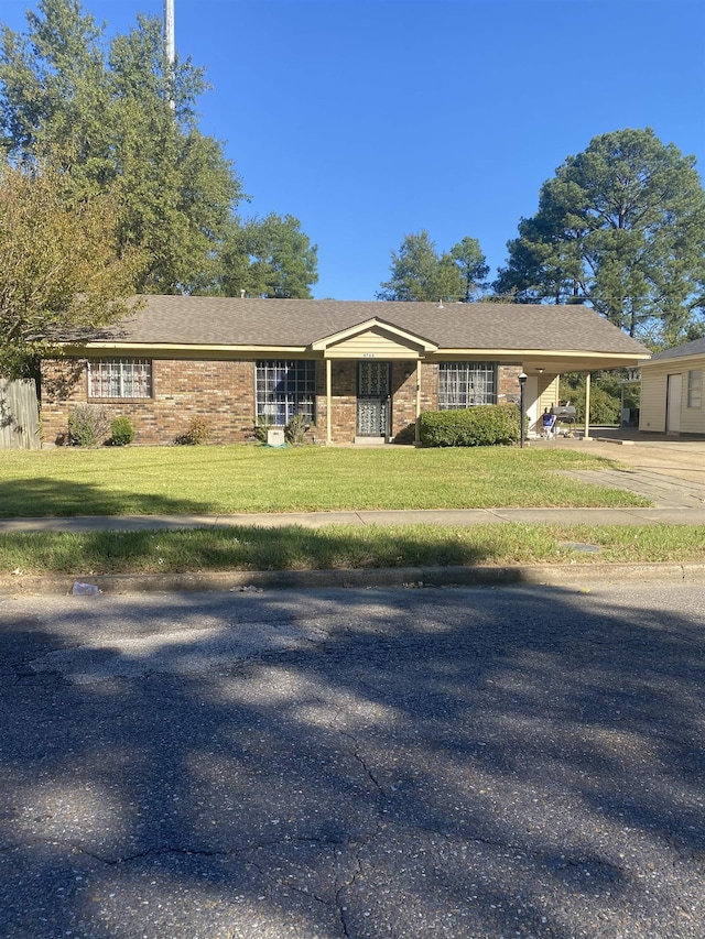 ranch-style house with a carport and a front lawn