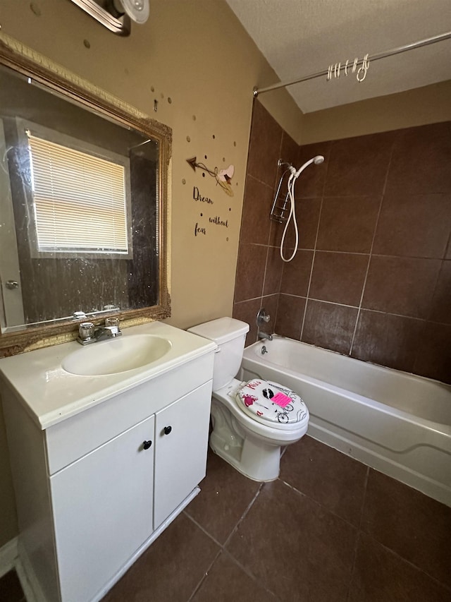 full bathroom with vanity, tiled shower / bath combo, tile patterned floors, and toilet