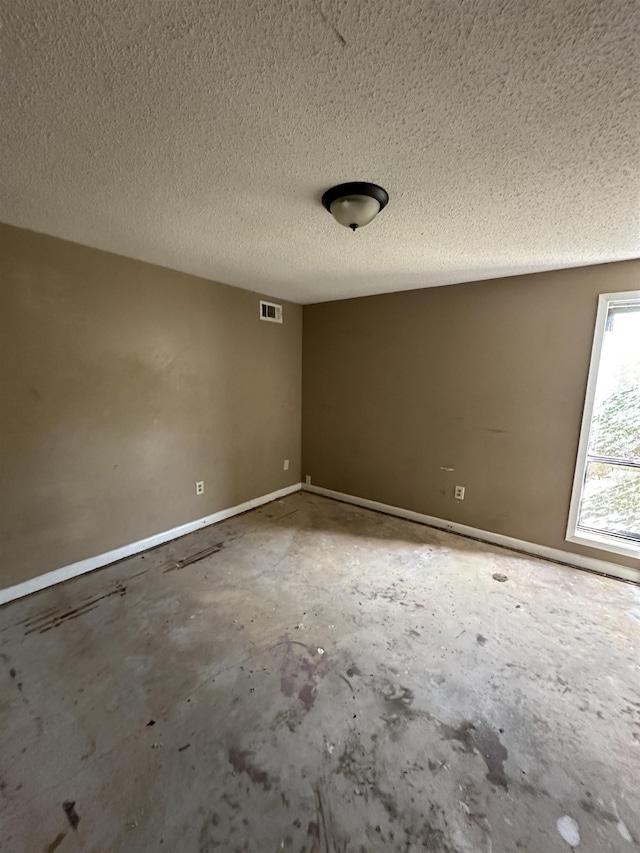 spare room with a textured ceiling