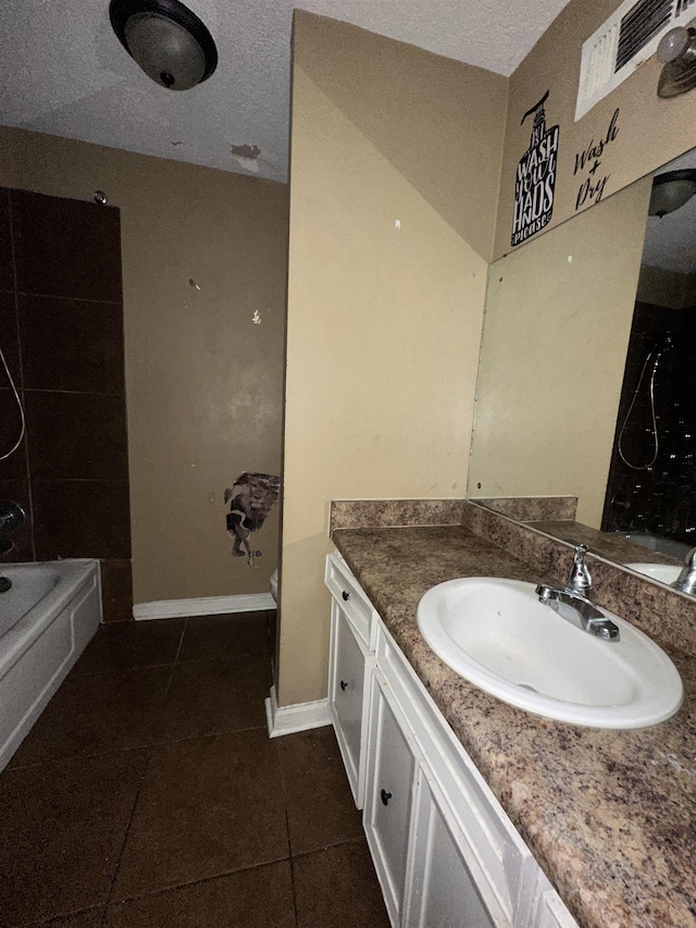 full bathroom with shower / tub combination, tile patterned flooring, vanity, a textured ceiling, and toilet