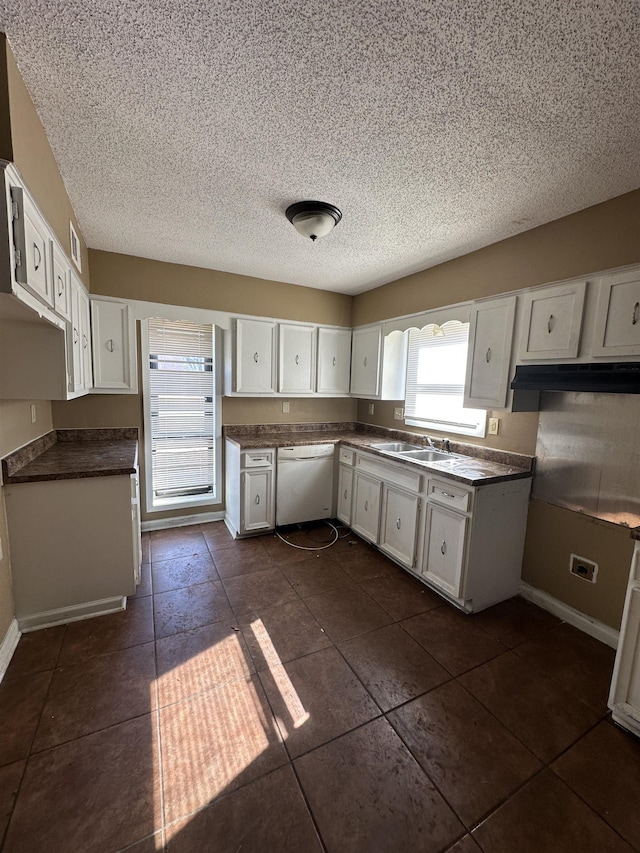 kitchen featuring sink, a textured ceiling, white cabinets, and white dishwasher