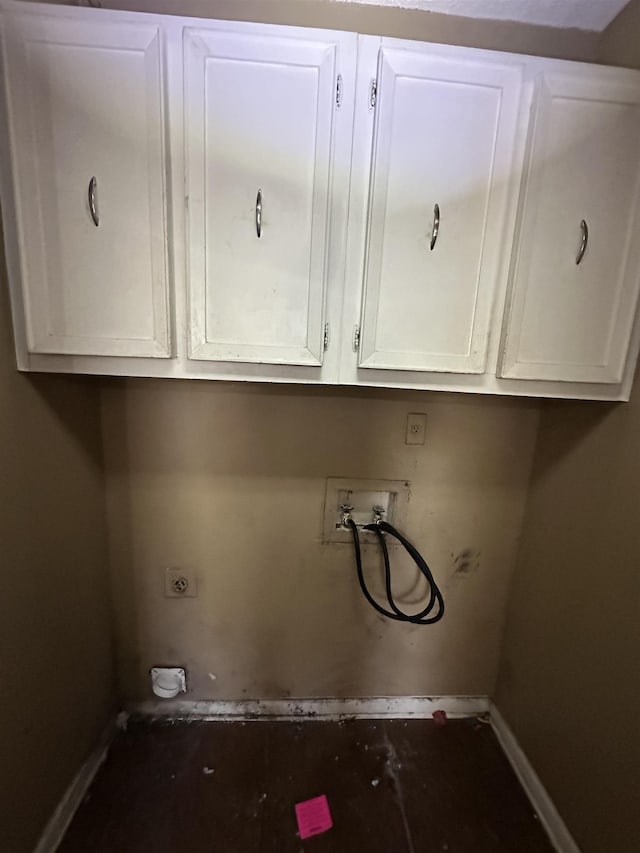 clothes washing area with hookup for a washing machine, cabinets, and hookup for an electric dryer