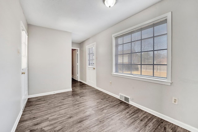 empty room featuring dark wood-type flooring