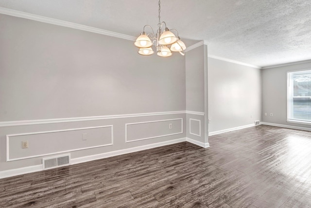 empty room with crown molding, dark hardwood / wood-style floors, an inviting chandelier, and a textured ceiling