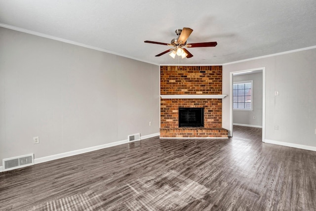 unfurnished living room with dark hardwood / wood-style floors, a fireplace, ornamental molding, ceiling fan, and a textured ceiling