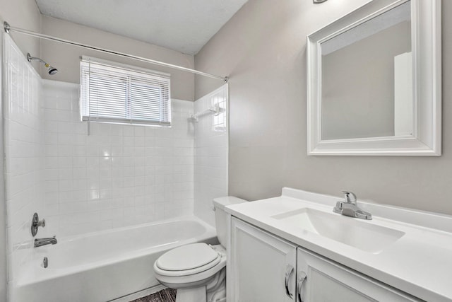 full bathroom with vanity, toilet, and tiled shower / bath