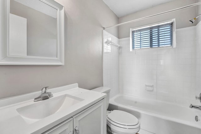 full bathroom with vanity, tiled shower / bath combo, and toilet