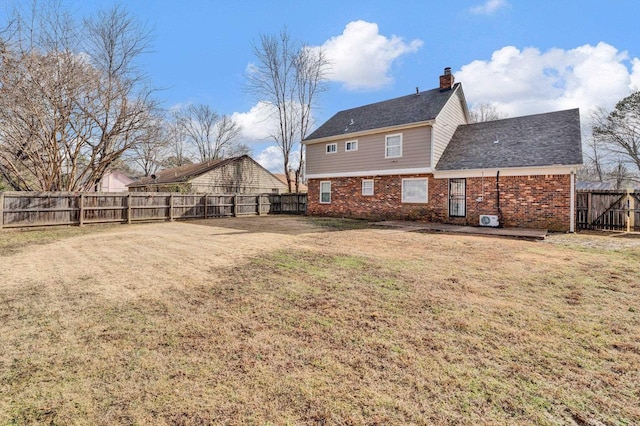 rear view of property with a yard