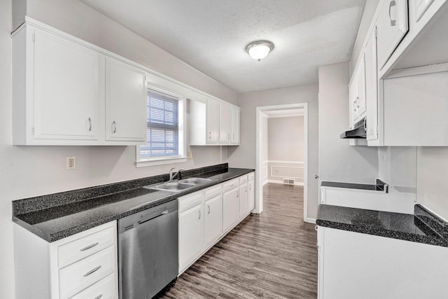 kitchen featuring sink, white cabinetry, a textured ceiling, dark hardwood / wood-style flooring, and stainless steel dishwasher