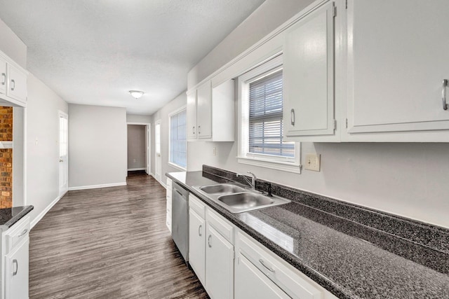 kitchen with sink, dark wood-type flooring, a textured ceiling, white cabinets, and stainless steel dishwasher