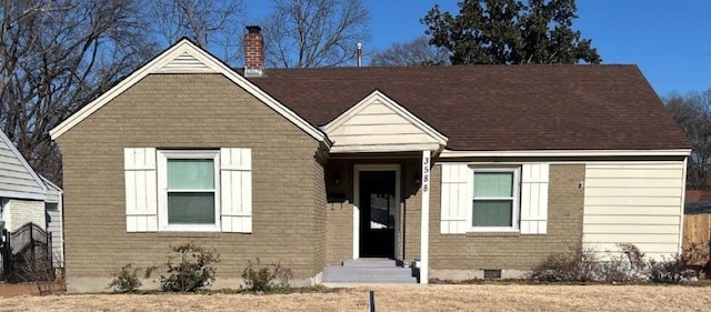 view of front of house featuring brick siding, crawl space, entry steps, and a chimney