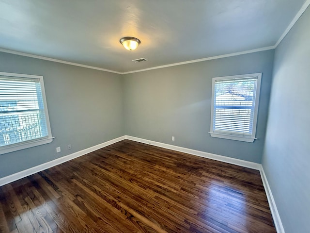 empty room featuring crown molding and dark wood-type flooring