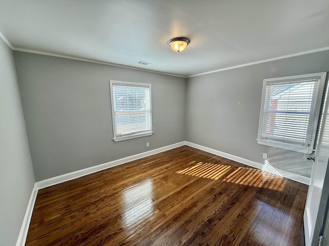 unfurnished room featuring crown molding, plenty of natural light, and dark hardwood / wood-style floors