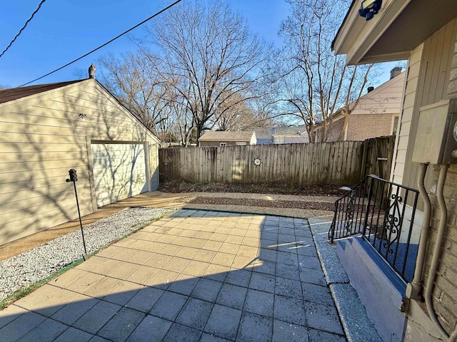 view of patio featuring a garage and an outdoor structure