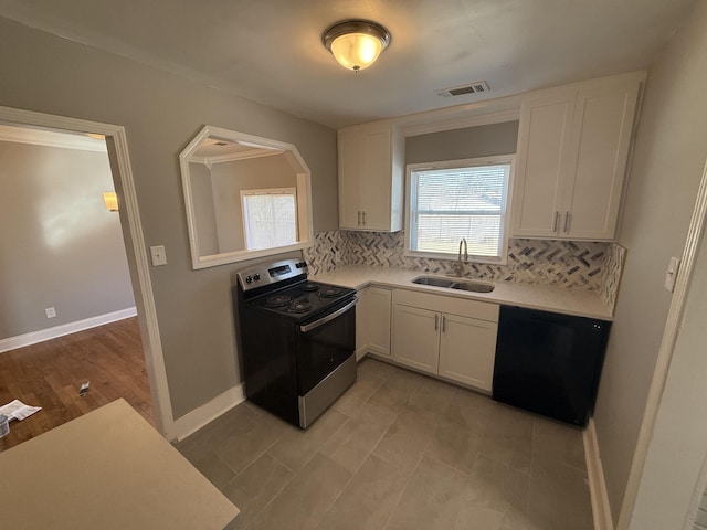 kitchen featuring visible vents, dishwasher, light countertops, electric stove, and a sink