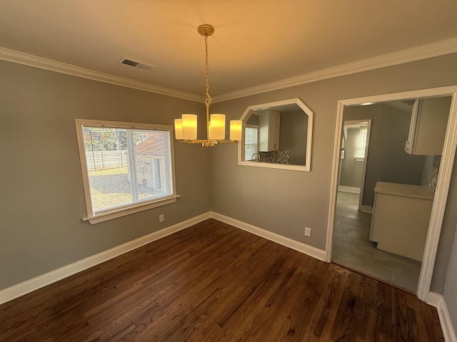 unfurnished dining area featuring ornamental molding, dark wood-type flooring, and a notable chandelier