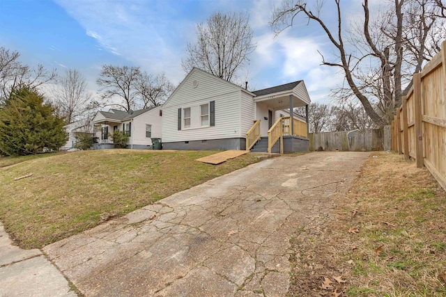 view of property exterior featuring a porch and a lawn