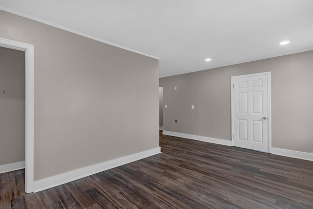 empty room with crown molding and dark hardwood / wood-style floors