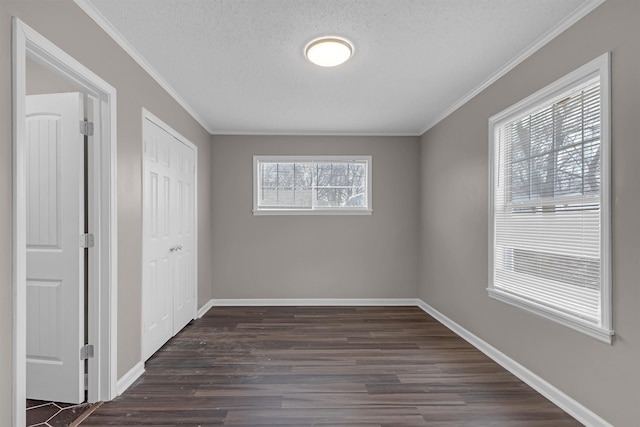 unfurnished bedroom featuring crown molding, a closet, dark hardwood / wood-style flooring, and a textured ceiling