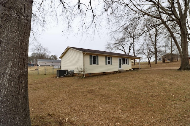 exterior space with central AC and a front lawn