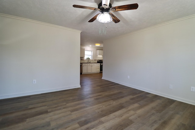 empty room featuring dark hardwood / wood-style floors, sink, ornamental molding, ceiling fan, and a textured ceiling