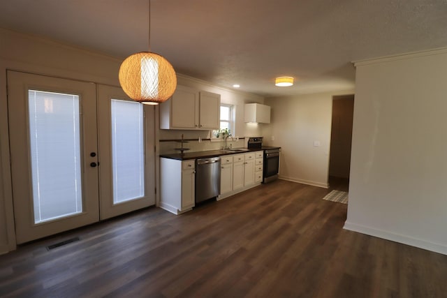 kitchen with white cabinets, hanging light fixtures, stainless steel appliances, crown molding, and french doors