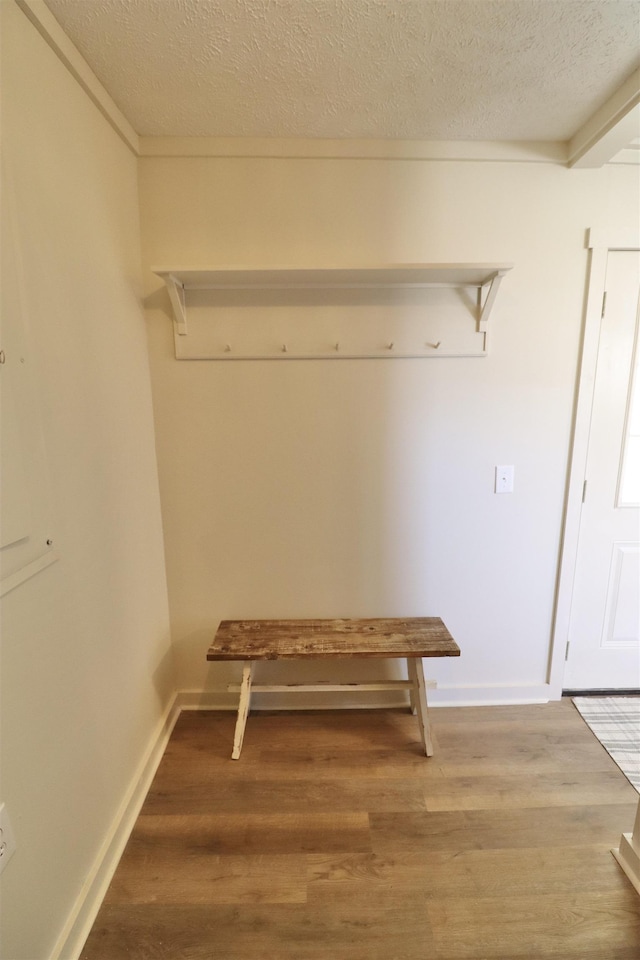 mudroom featuring hardwood / wood-style floors and a textured ceiling