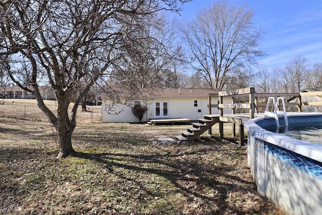 rear view of property with french doors and a swimming pool side deck