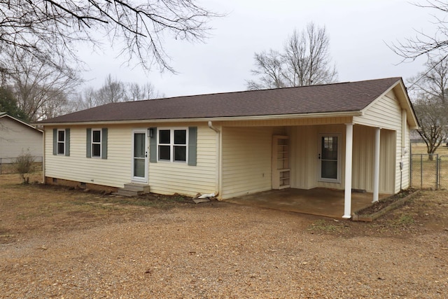 view of front of house with fence, driveway, roof with shingles, entry steps, and crawl space