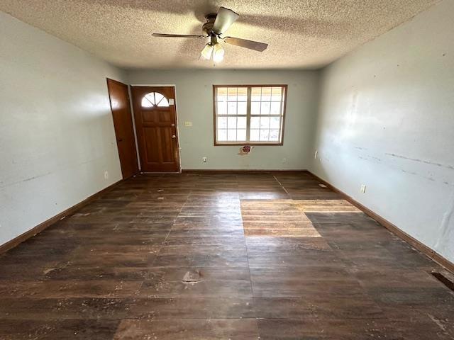 foyer with dark hardwood / wood-style floors, a textured ceiling, and ceiling fan