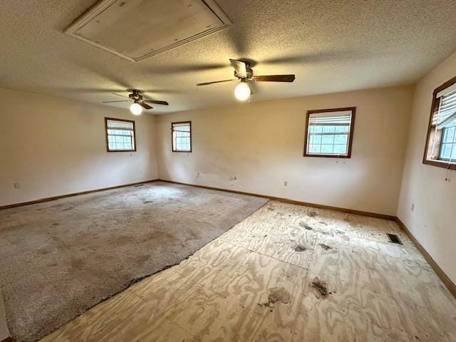 unfurnished room featuring light colored carpet and a textured ceiling