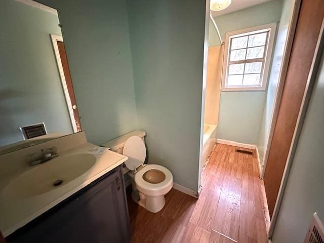 bathroom with vanity, hardwood / wood-style flooring, and toilet