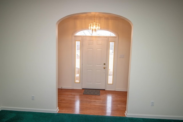 entrance foyer featuring hardwood / wood-style flooring and a chandelier