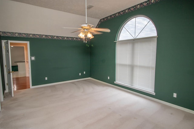 carpeted spare room with ceiling fan