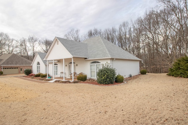 view of front facade featuring a porch and a garage