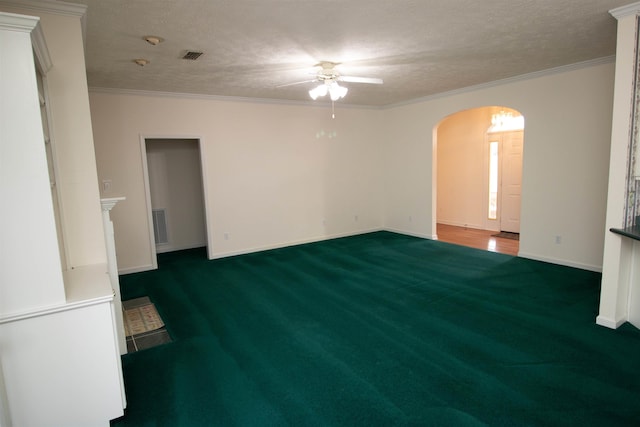 carpeted spare room with ceiling fan, ornamental molding, and a textured ceiling