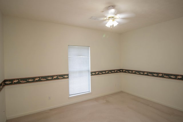 carpeted empty room featuring ceiling fan