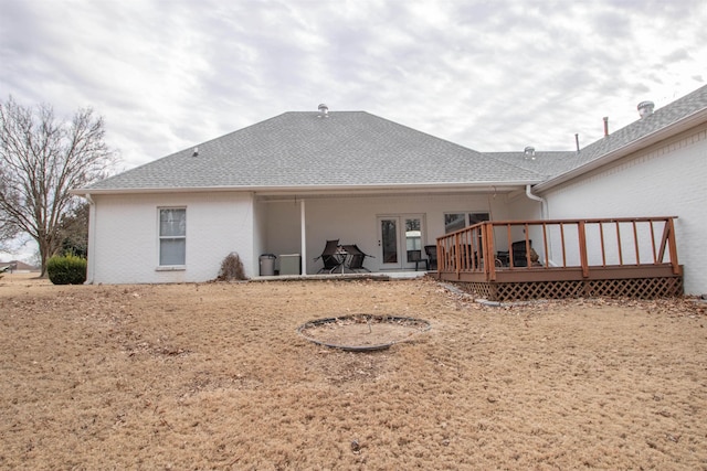 back of house featuring a wooden deck