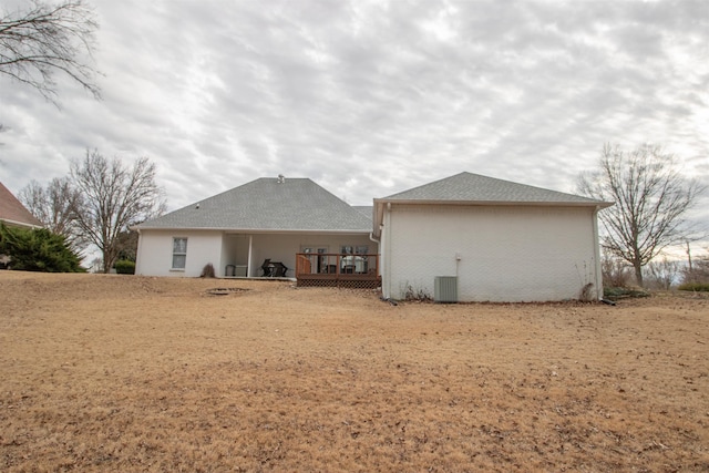 rear view of property featuring a yard, central AC, and a deck