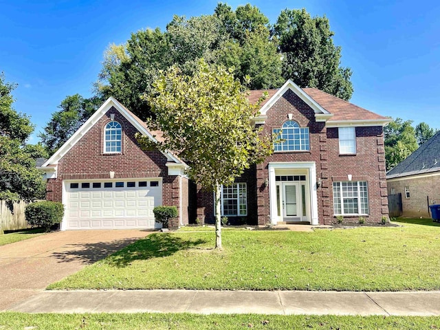 front of property with a garage and a front lawn