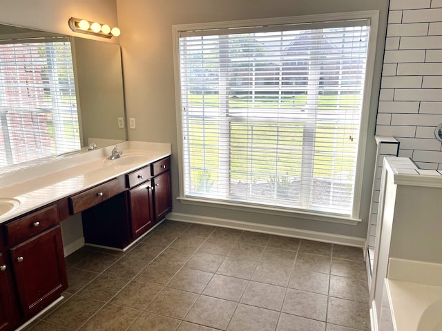 bathroom featuring vanity, a bath, tile patterned flooring, and a wealth of natural light