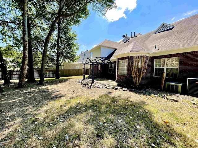 view of yard with central AC and a patio area